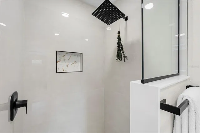 a bedroom with a bed and a mirror