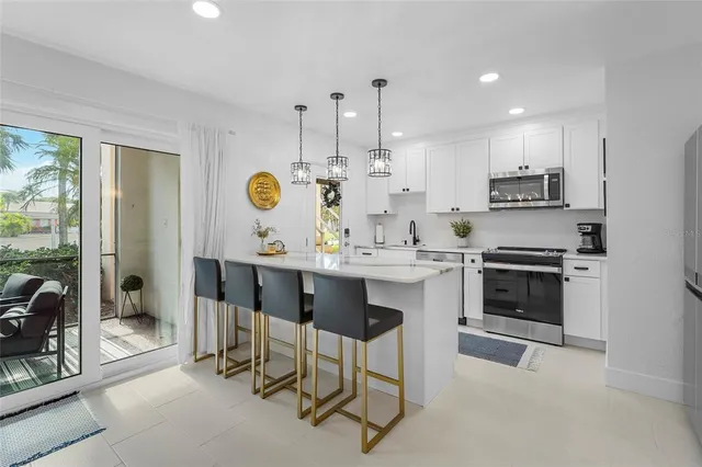 a kitchen with a stove and a refrigerator