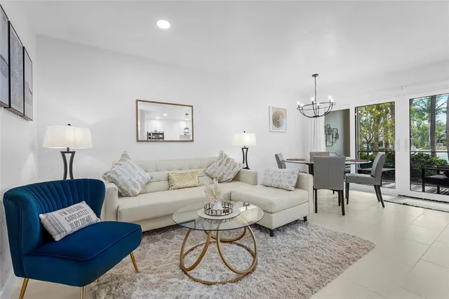 a living room with furniture potted plant and a large window