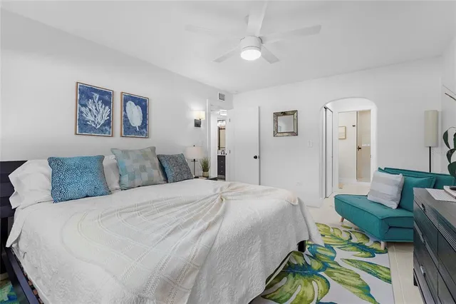 a spacious bedroom with a bed and a couch