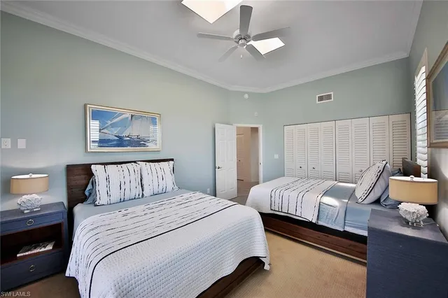 a bedroom with two beds and a chandelier
