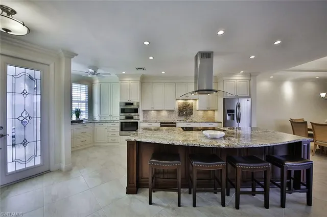 a kitchen with kitchen island granite countertop a table and chairs in it