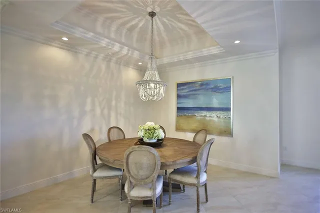a view of a dining room with furniture and chandelier