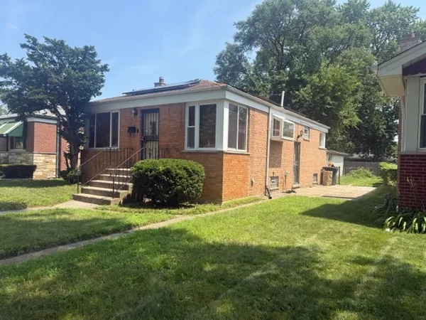 a view of a house with a yard and sitting area