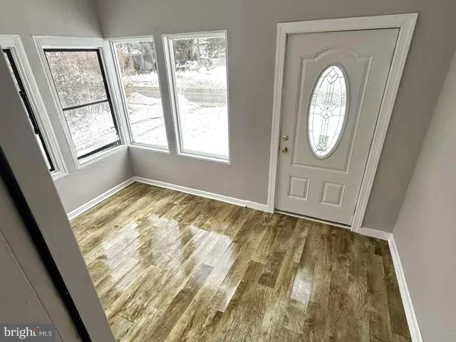 a kitchen with granite countertop a refrigerator and a sink