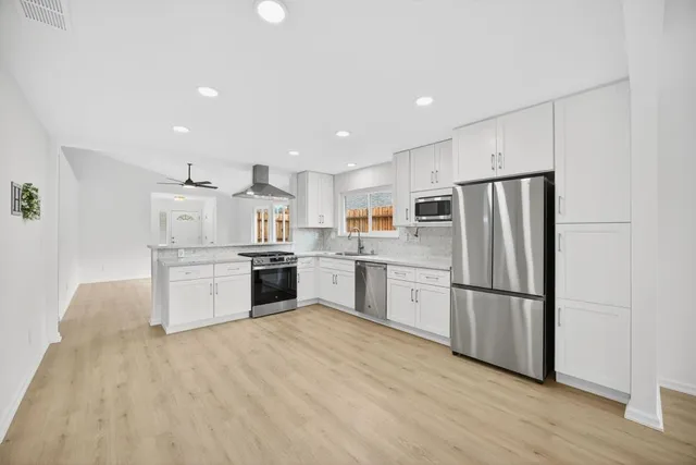 a kitchen with stainless steel appliances granite countertop a stove and a sink