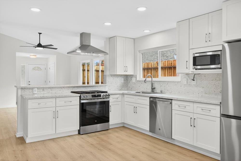 6237 Riverbelle Court Rio Linda, CA 95673 - Photo 14 of 50 a kitchen with stainless steel appliances granite countertop a stove and a sink