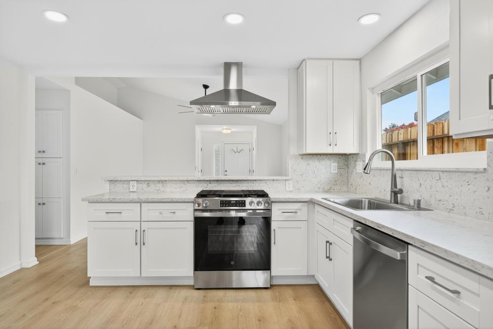 6237 Riverbelle Court Rio Linda, CA 95673 - Photo 15 of 50 a kitchen with a stove sink and cabinets
