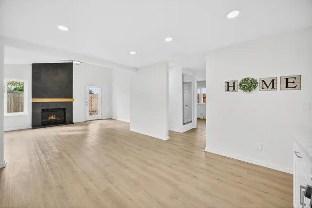 a view of empty room with a fireplace