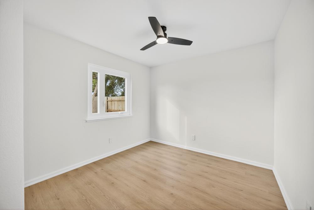 6237 Riverbelle Court Rio Linda, CA 95673 - Photo 23 of 50 a view of an empty room with wooden floor and a ceiling fan