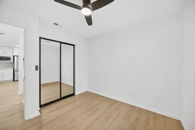 a bathroom with a shower sink vanity mirror and toilet