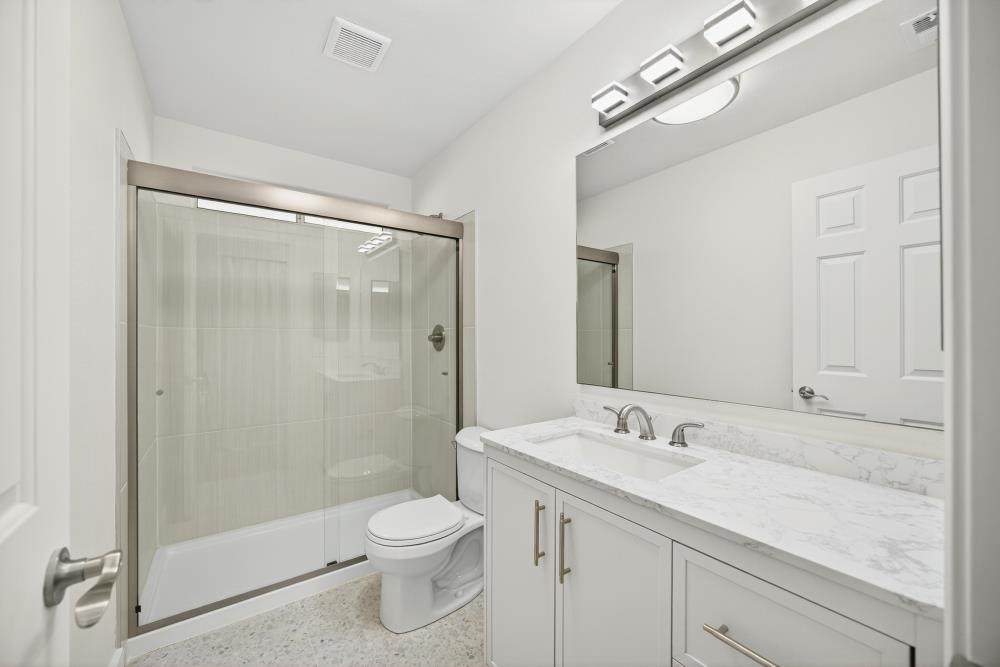6237 Riverbelle Court Rio Linda, CA 95673 - Photo 28 of 50 a bathroom with a shower sink vanity mirror and toilet