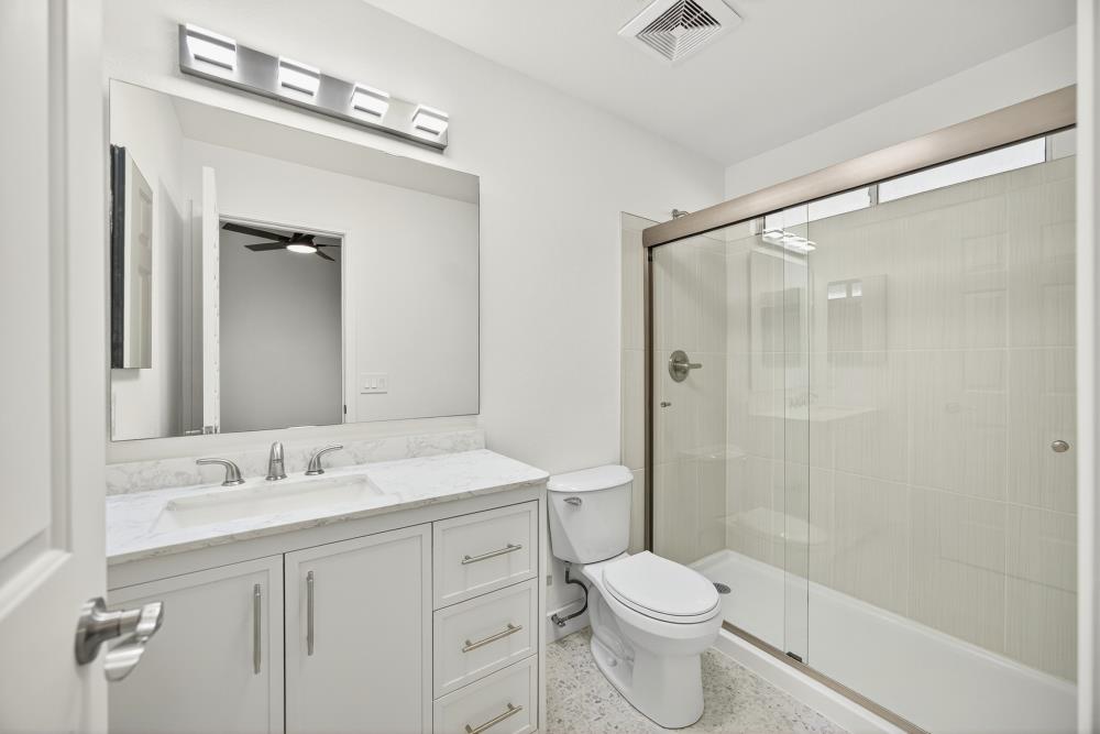 6237 Riverbelle Court Rio Linda, CA 95673 - Photo 37 of 50 a bathroom with a sink a toilet a mirror and shower