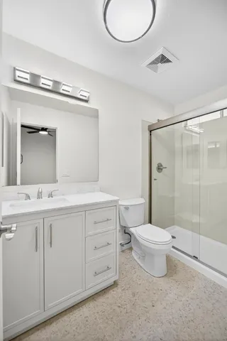 a bathroom with a glass shower door