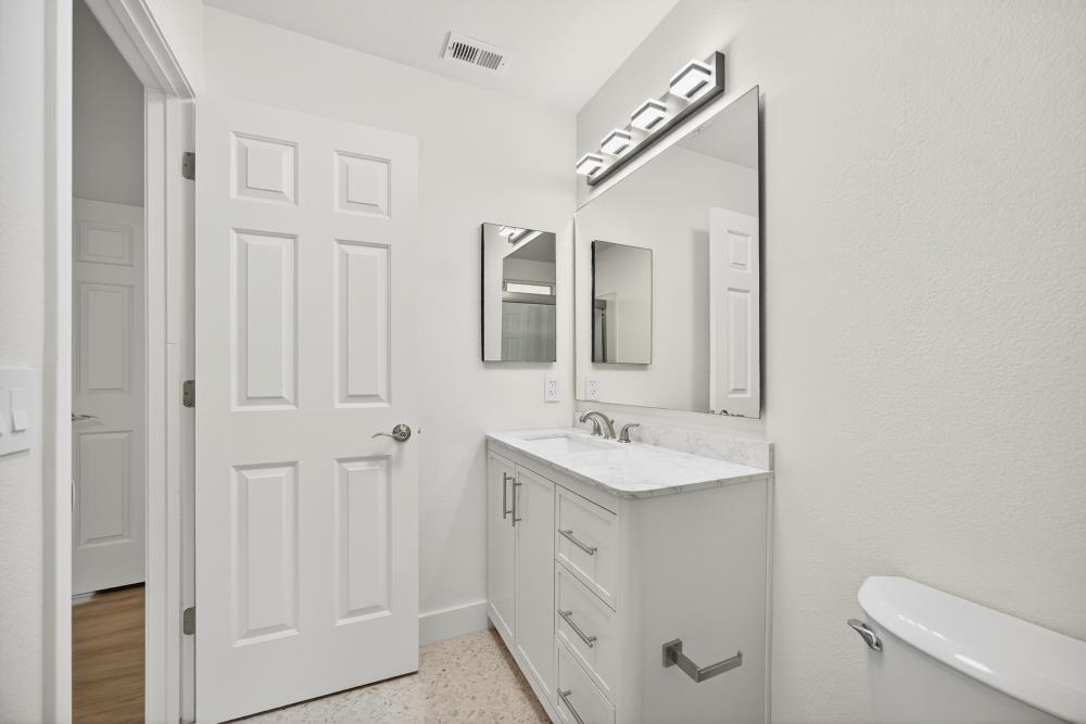 6237 Riverbelle Court Rio Linda, CA 95673 - Photo 40 of 50 a spacious bathroom with a double vanity sink a mirror and a toilet