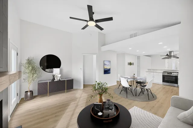 a living room with furniture and a wooden floor