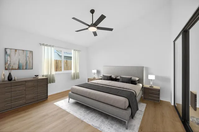 a bedroom with a large bed and a window