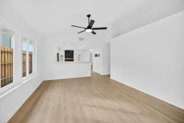 wooden floor in an empty room with a window