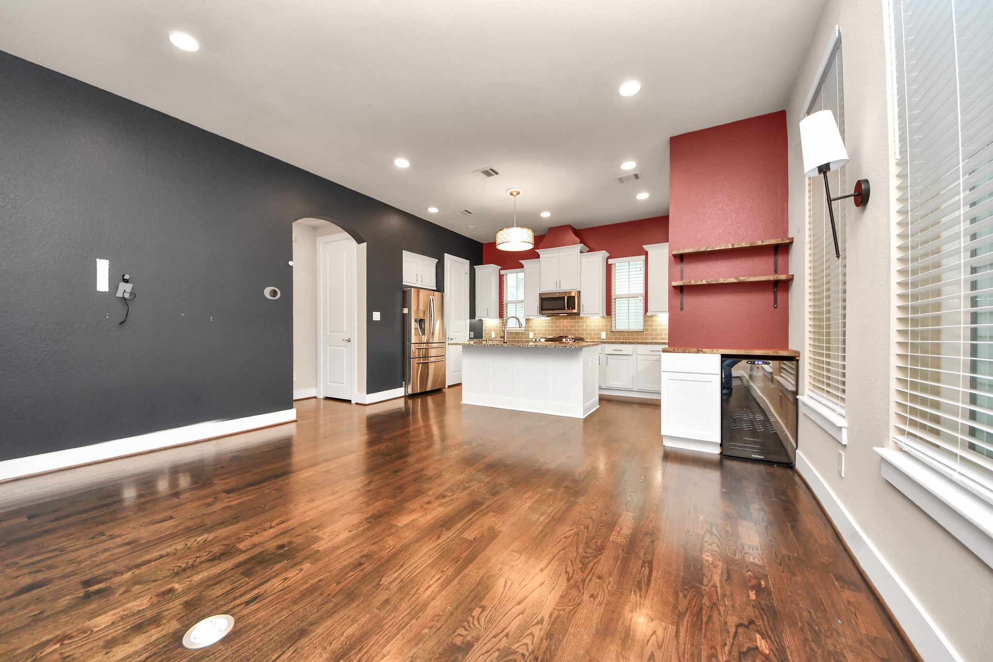 2704 Freund Street Houston, TX 77003 - Photo 12 of 45 a view of a kitchen with kitchen island wooden floors stainless steel appliances and windows