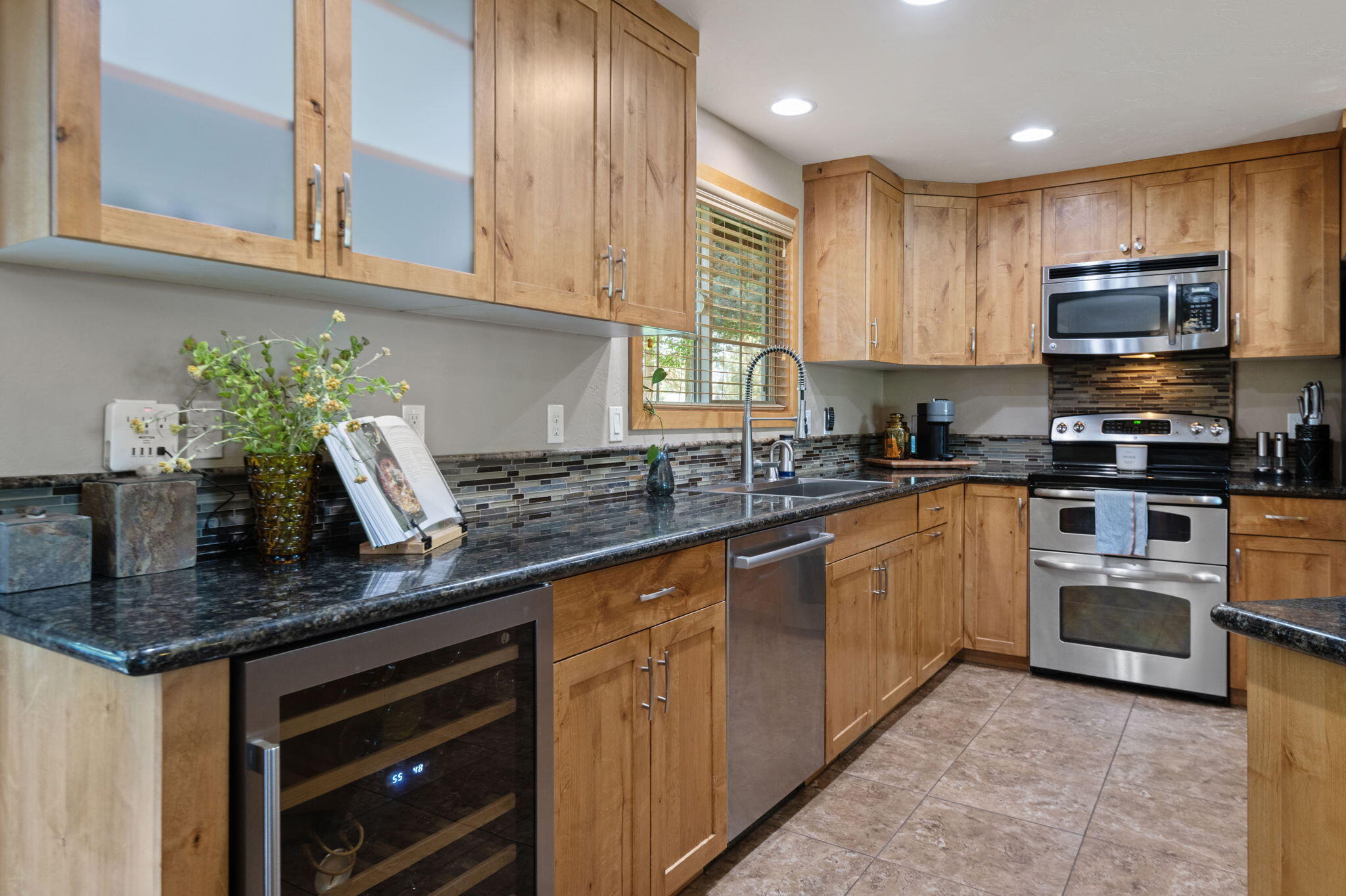 22539 Martee Lane Bend, OR 97701 - Photo 10 of 54 a kitchen with stainless steel appliances granite countertop a sink a stove and cabinets