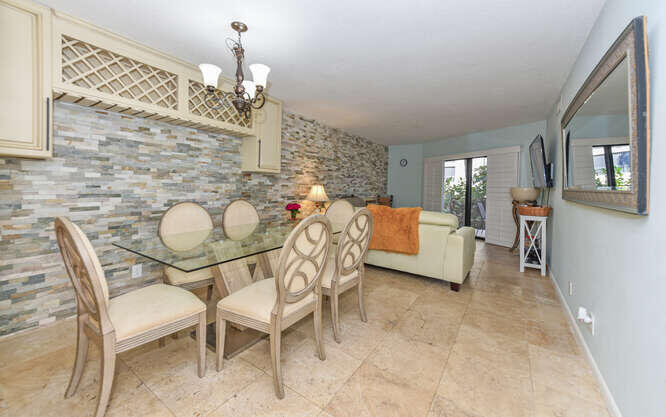 420 Celestial Way, Unit 101 Juno Beach, FL 33408 - Photo 14 of 39 a dining room with furniture and window