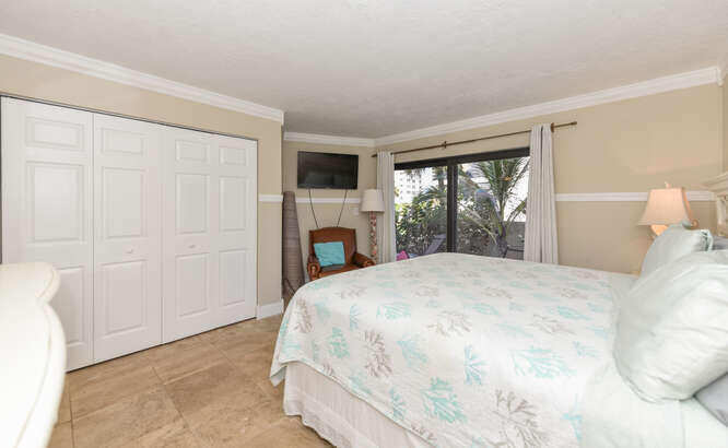 420 Celestial Way, Unit 101 Juno Beach, FL 33408 - Photo 17 of 39 a bedroom with a bed and a window