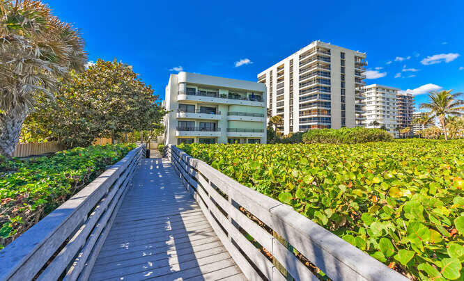 420 Celestial Way, Unit 101 Juno Beach, FL 33408 - Photo 28 of 39 a view of balcony with a couple of cars parked in front of a house