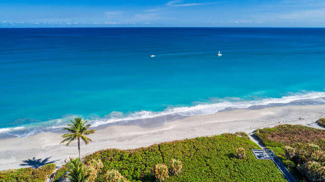 420 Celestial Way, Unit 101 Juno Beach, FL 33408 - Photo 31 of 39 a view of a lawn chair and an umbrella in patio