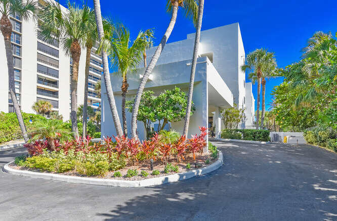 420 Celestial Way, Unit 101 Juno Beach, FL 33408 - Photo 38 of 39 a front view of a house with a yard and plant