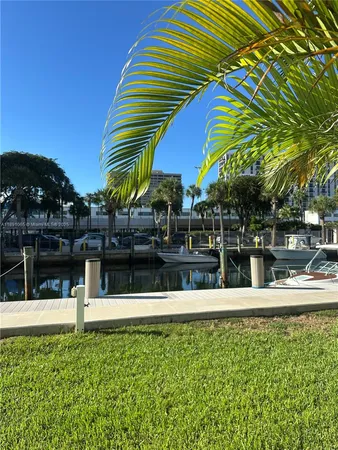 a view of swimming pool with a lawn chairs under an umbrella