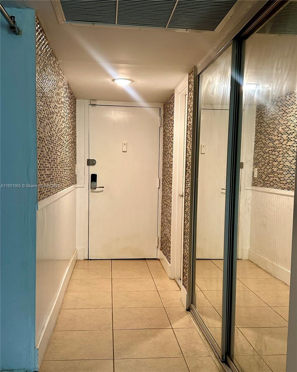 1650 Northeast 115th Street, Unit 102 Miami, FL 33181 - Photo 16 of 18 a view of a hallway with wooden floor