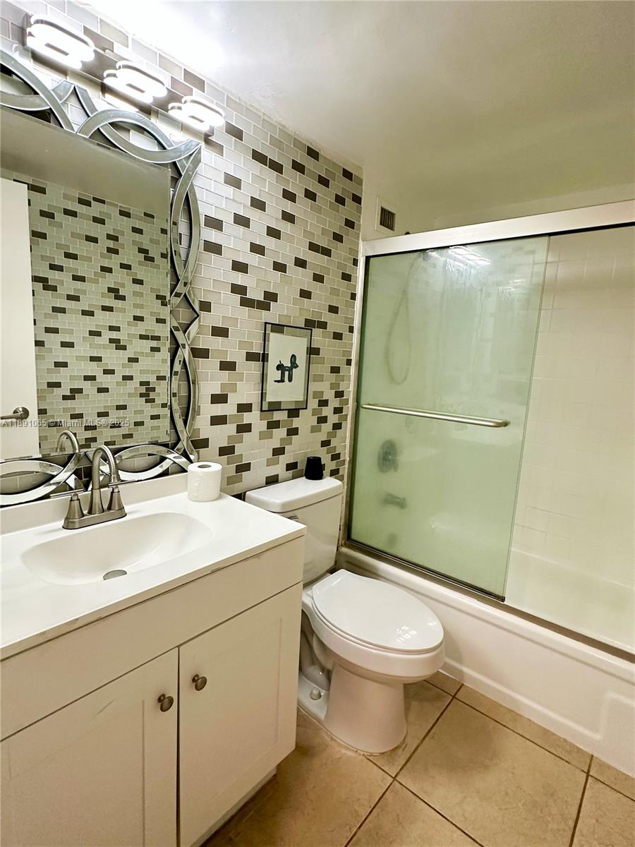 1650 Northeast 115th Street, Unit 102 Miami, FL 33181 - Photo 18 of 18 a bathroom with a sink toilet and shower