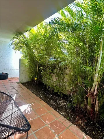 a view of backyard with plants and outdoor seating