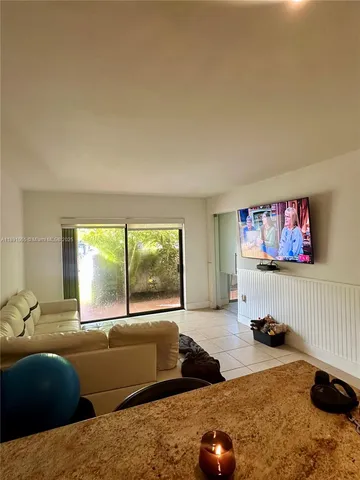 a living room with furniture window and a flat screen tv