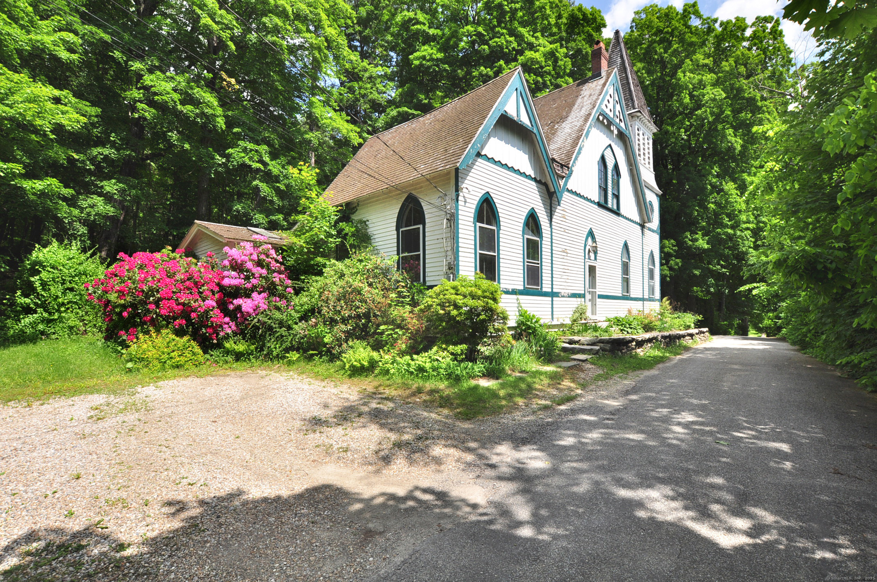 a view of a house with a backyard and garden