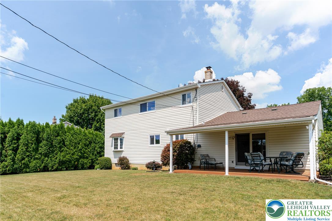 2130 Wisteria Road Lower Macungie Township, PA 18062 - Photo 44 of 48 A broad, verdant lawn extends from a multi-story home featuring siding and a charming covered deck.