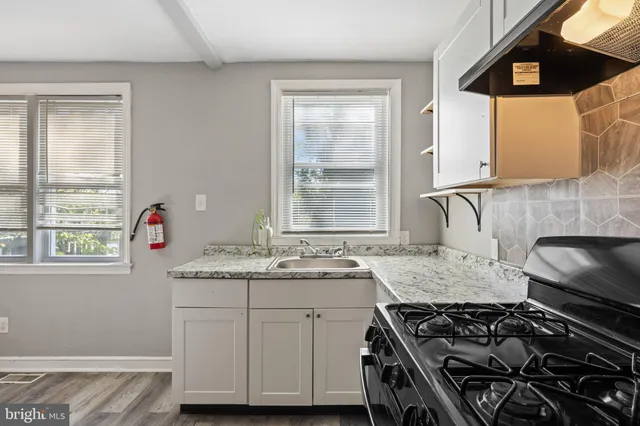 a kitchen that has a sink and a stove
