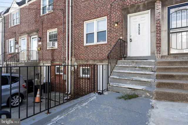 a view of a house with iron fence