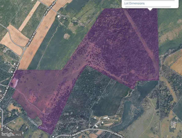 a view of a dry yard with wooden fence