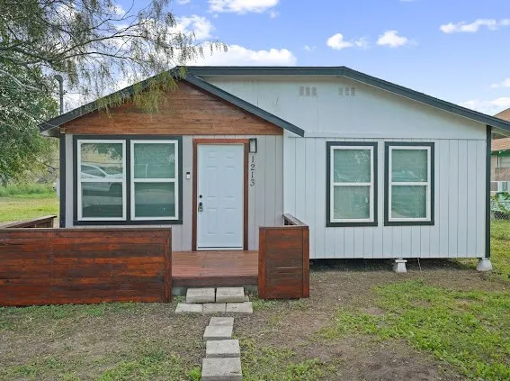 a front view of a house with garden