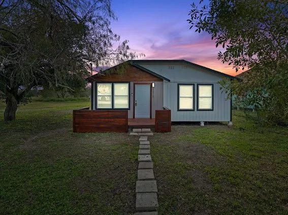 a front view of a house with a garden