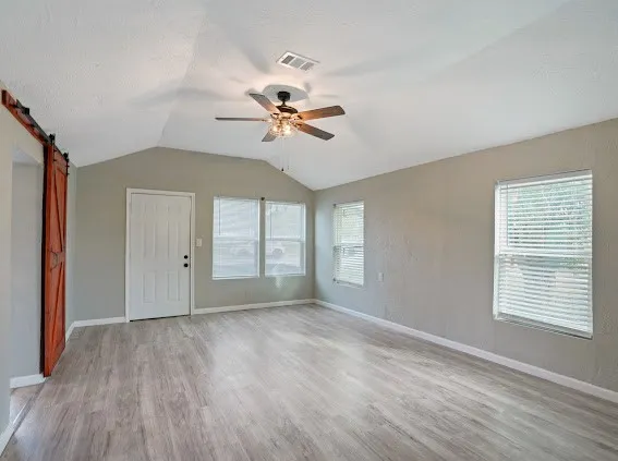 a view of room with a ceiling fan and window