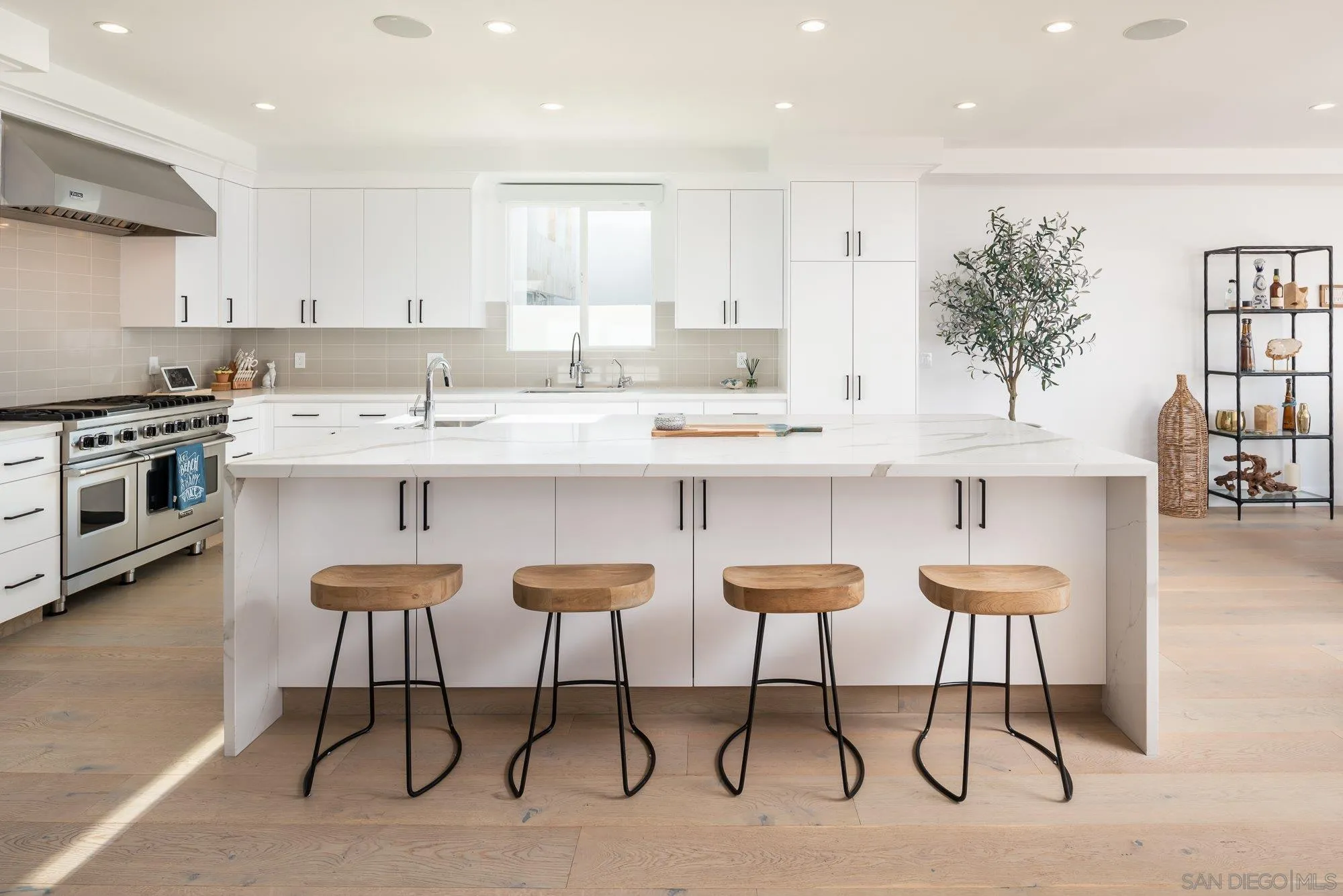 21 Green Turtle Road Coronado, CA 92118 - Photo 18 of 55 a kitchen with stainless steel appliances a table chairs refrigerator and cabinets