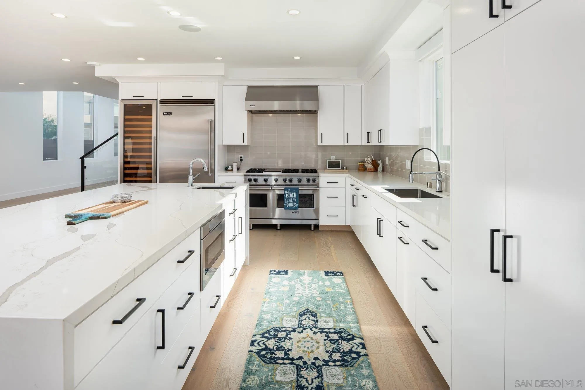 21 Green Turtle Road Coronado, CA 92118 - Photo 19 of 55 a large white kitchen with a stove a sink a refrigerator and white cabinets