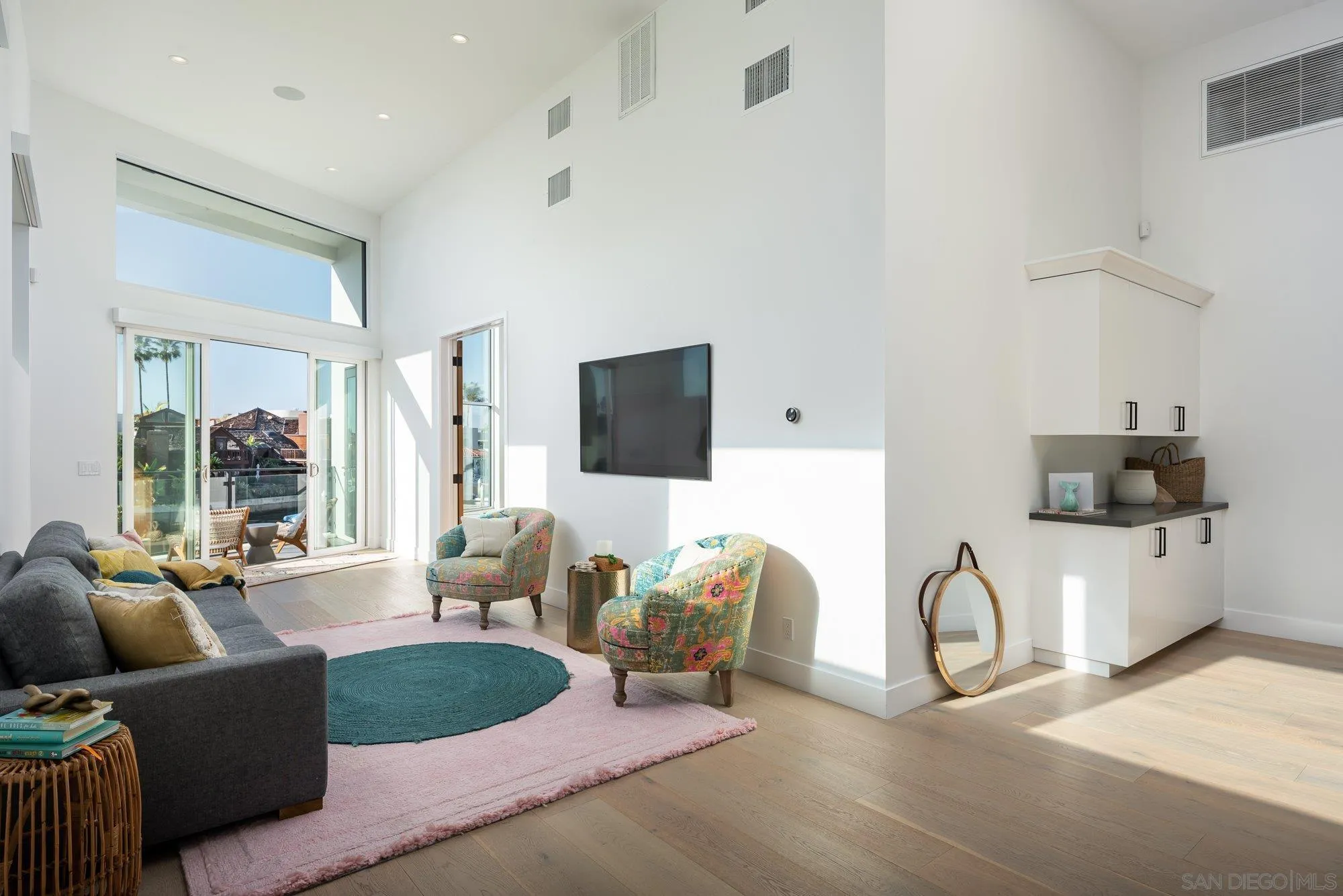 21 Green Turtle Road Coronado, CA 92118 - Photo 26 of 55 a living room with furniture a flat screen tv and a table