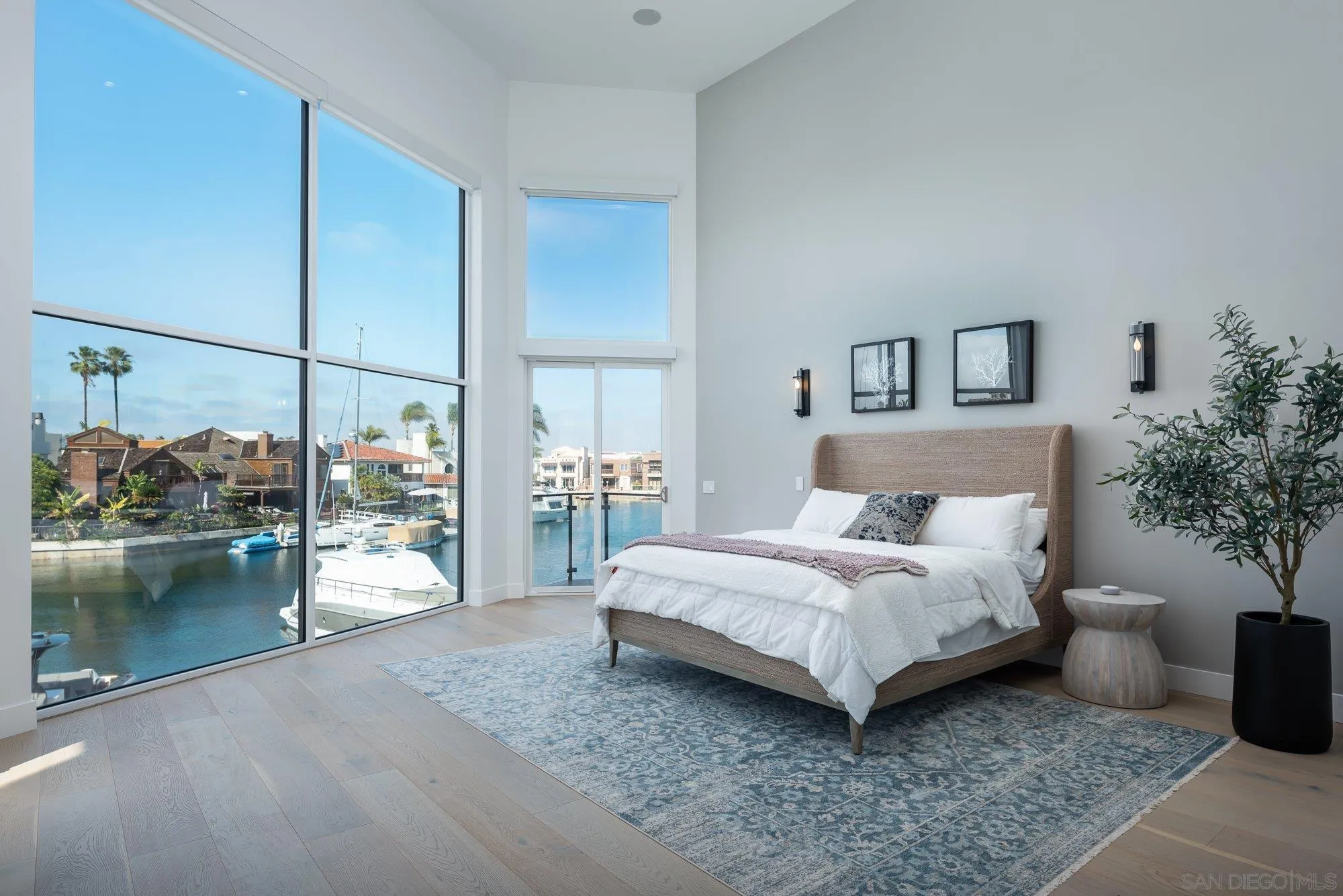 21 Green Turtle Road Coronado, CA 92118 - Photo 31 of 55 a spacious bedroom with a bed and a table