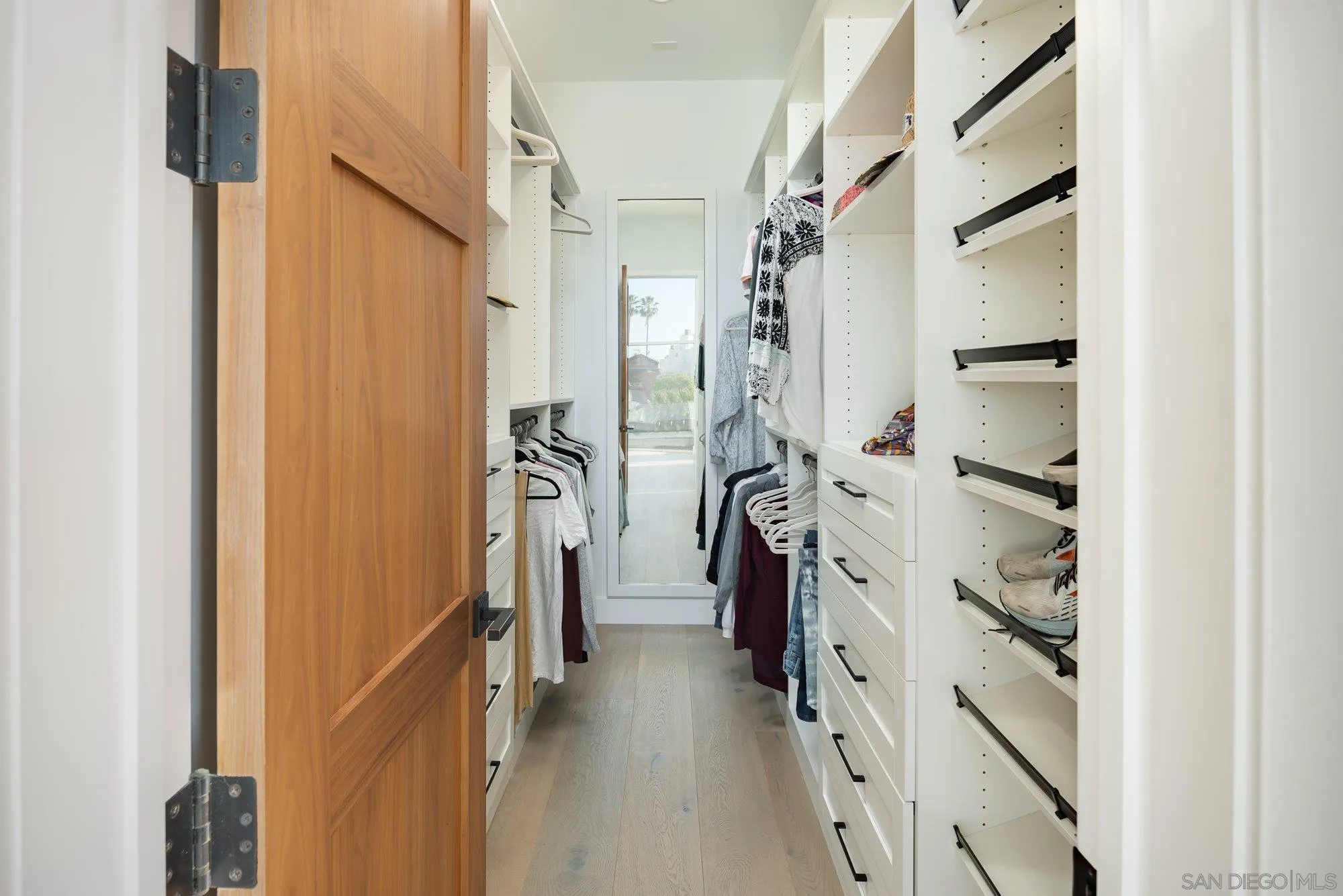 21 Green Turtle Road Coronado, CA 92118 - Photo 38 of 55 a view of walk in closet with clothes and shoes