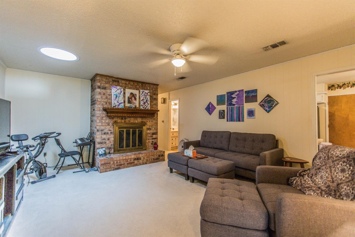 7901 Aberdeen Avenue Lubbock, TX 79424 - Photo 2 of 10 a living room with furniture a ceiling fan and a window