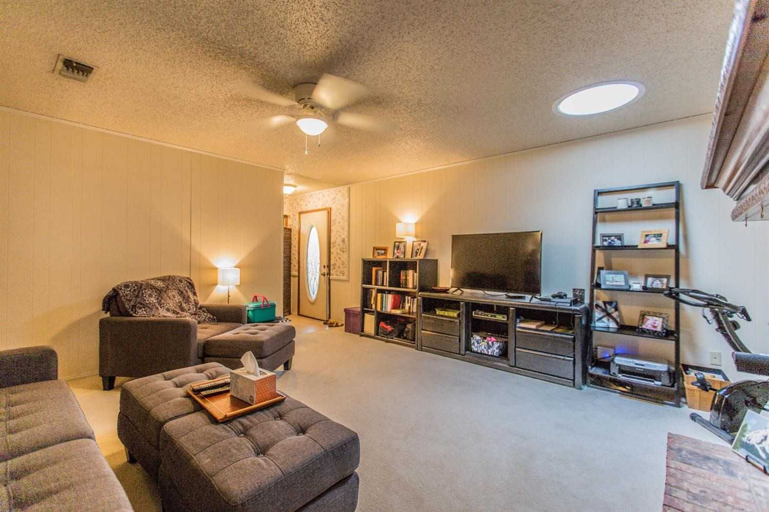 7901 Aberdeen Avenue Lubbock, TX 79424 - Photo 3 of 10 a living room with furniture and a flat screen tv