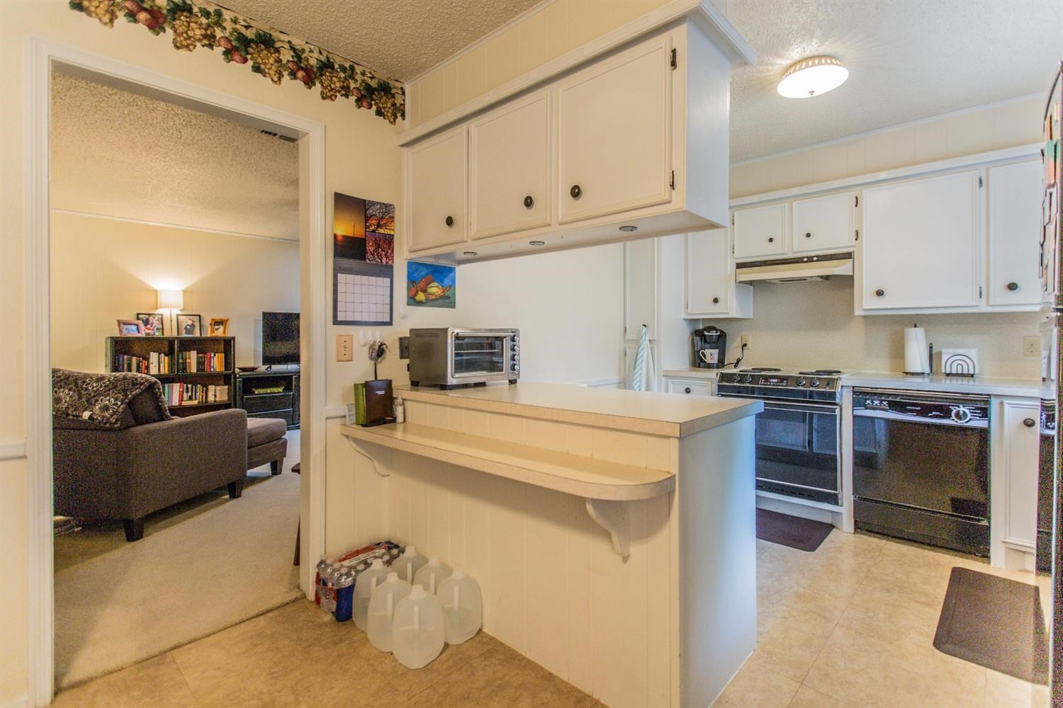 7901 Aberdeen Avenue Lubbock, TX 79424 - Photo 6 of 10 a kitchen with kitchen island a stove a sink and a refrigerator